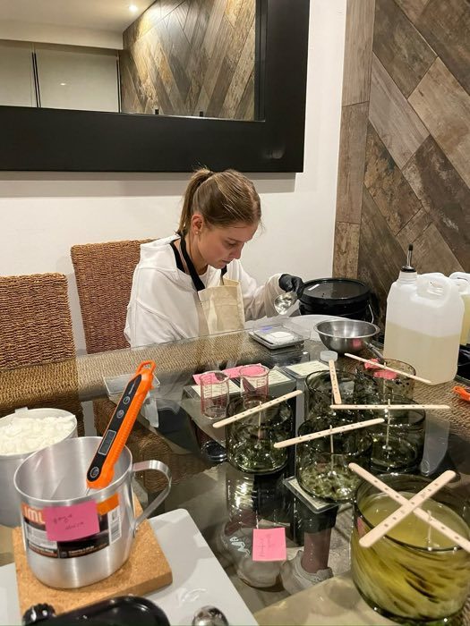 Annette Serio Haddad hand-pouring and weighing SOREIA candles